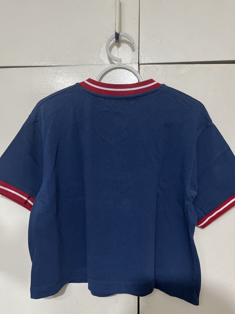 Pull & Bear Navy Blue Manhattan Midtown Cropped T-shirt (Category: Shirts) located in Paranaque City. Submitted by iya.dcltr (Listing ID 1464589620, Image 3). Description: - Navy blue cropped t-shirt - Brand: Pull & Bear - V-neck with red and white trim - Front graphic: 'Manhattan Midtown Diamond District' - Short sleeves with matching trim - Perfect for a casual, sporty look - Pairs well with jeans or shorts.