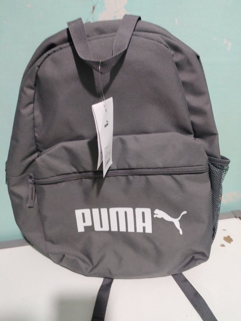 Puma Grey Backpack (Category: Backpacks) located in Quezon City. Submitted by vie14 (Listing ID 1464668599, Image 1). Description: - Brand new grey Puma backpack - Still has original tags attached - Features iconic Puma logo on the front - Includes a convenient front zipper pocket - Side mesh pocket for water bottle or essentials - Ideal for school, gym, or everyday adventures.