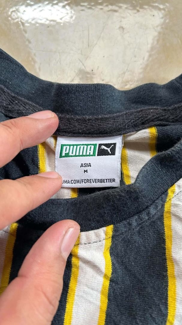 PUMA Downtown Stripe Tee (Category: Tshirts & Polo Shirts ) located in General Santos City (Dadiangas). Submitted by moana_thrifts (Listing ID 1464629407, Image 3). Description: - Brand: Puma - Size: M (Asia fit) - Design: Black, white, and yellow stripes - Features: Large Puma logo graphic on the front - Ideal for: Casual wear - Condition: Please check photos for detailed condition..