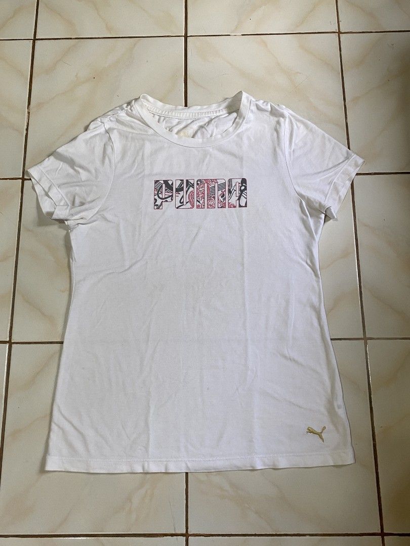 Puma White Graphic Logo T-Shirt (Category: Shirts) located in Roxas City. Submitted by xyddvs (Listing ID 1464602374, Image 1). Description: W 19 L 27 slight line cracks.