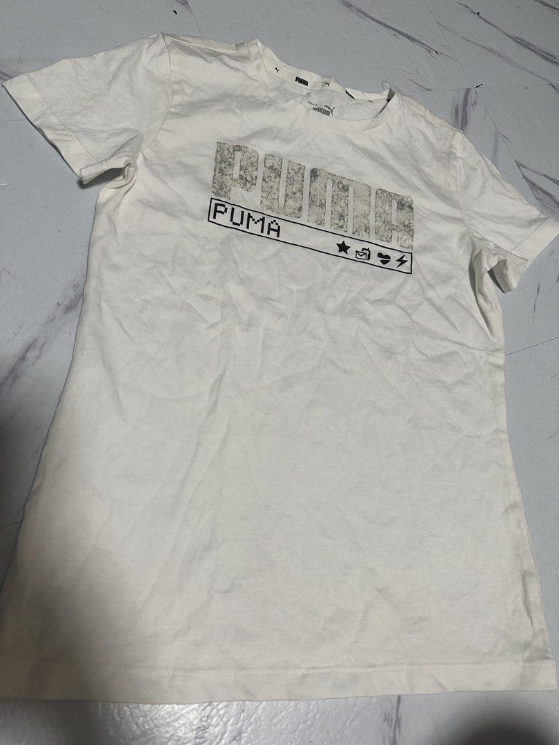 Puma White Graphic Tee (Category: Babies & Kids Fashion) located in Manila. Submitted by tipidfinds888 (Listing ID 1464731406, Image 1). Description: - Color: White - Design: Distressed pixel Puma logo on chest with secondary icon box logo - Neckline: Crew neck - Sleeves: Short sleeves - Style: Casual everyday wear, pairs easily with jeans or shorts .