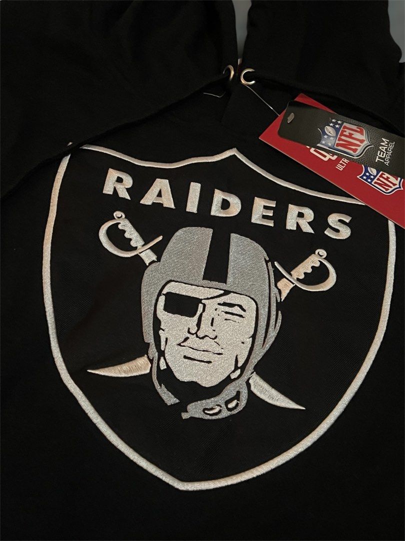 Raiders Hoodie (Category: Coats, Jackets and Outerwear) located in Apalit. Submitted by giecortez15 (Listing ID 1464605124, Image 3). Description: - Black Las Vegas Raiders hoodie - Embroidered Raiders shield logo on front - Contrasting grey and white sleeve panels - Hood with drawstrings - NFL Team Apparel by Ultra Game - Size: Medium - Made in China.