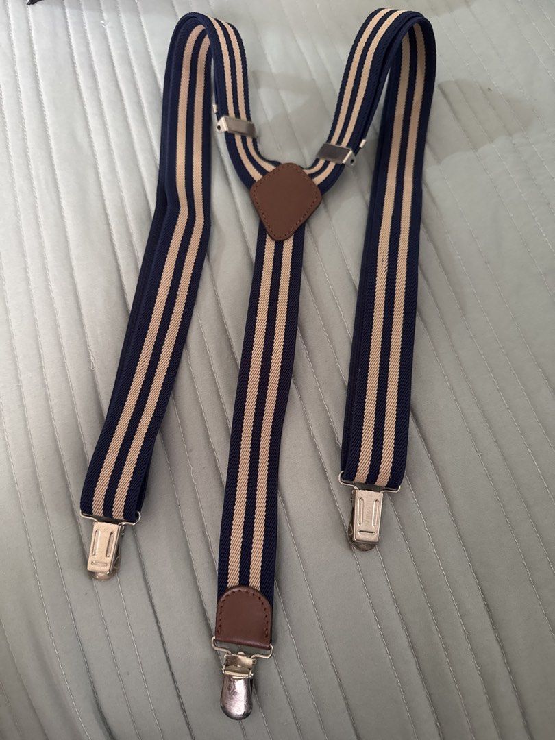 Red and Striped Suspenders with Clips (Category: Ties) located in Santa Cruz. Submitted by liacong (Listing ID 1464614637, Image 2). Description: - Set includes two pairs of suspenders: 1 solid red, 1 navy and tan striped. - Features durable metal clips for secure attachment. - Adjustable straps ensure a comfortable, customized fit. - Ideal for adding a touch of flair and sophistication to any outfit. - Sold together as a convenient bundle..