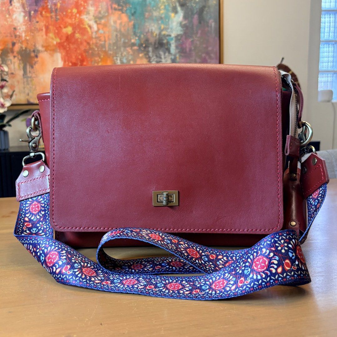 Red Leather Crossbody Bag with Patterned Strap (Category: Cross-body Bags) located in Pasig City. Submitted by bituin18 (Listing ID 1464575094, Image 1). Description: - Stylish red leather crossbody bag - Secure front clasp closure - Detachable patterned strap included - Convenient side bottle holder - Ideal for everyday wear - Approximately 11 inches wide.