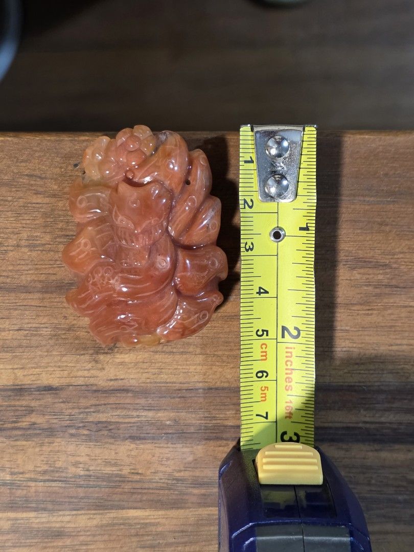 Red Quartz Crystal Carved Nine-Tailed Fox Pendant (Category: Charms) located in Manila. Submitted by alyayeah (Listing ID 1464697340, Image 3). Description: - Material: Rich red quartz stone with warm orange and amber tones - Design: Intricately carved nine-tailed fox with a flower and patterned back grooves - Size: Approximately 5 cm in length, big size! - Finish: Smooth and polished -Features a holes near the top for a cord or chain -Statement 