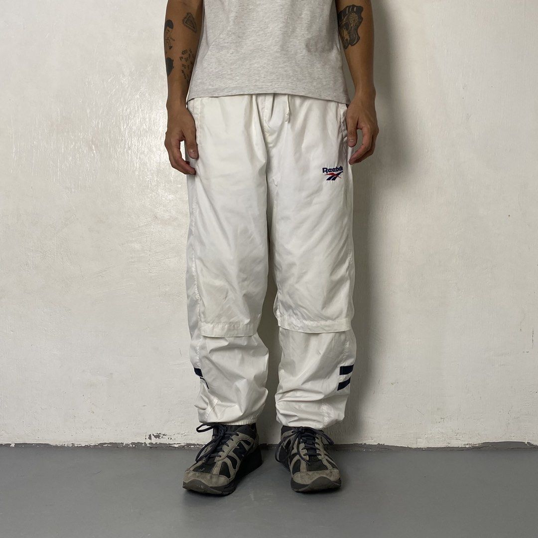 REEBOK 👟| White Baggy Track Pants (Category: Trousers) located in Bulacan. Submitted by orc.ph (Listing ID 1464688981, Image 2). Description: REEBOK 👟| White Baggy Track Pants Material Used: 100% Polyester -Straight-Leg -Baggy Silhouette -Adjustable Internal Drawchord -Gathered Elastic Waistband -Ankle Side Zippers -Side Slip Pockets -Outdoor -Streetwear -Casual Wear -Size: M-XL -Waistline: “32 | “36 (Stretched) -Length: “39 -Thighs: “13 -Leg O