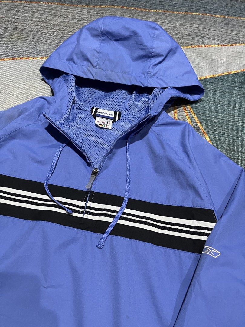 Reebok Blue Windbreaker Jacket with Black and White Stripes (Category: Coats, Jackets and Outerwear) located in Puerto Princesa. Submitted by dijaydj28 (Listing ID 1464590413, Image 2). Description: - Cool blue Reebok windbreaker jacket - Features a hood and half-zip closure - Stylish black stripe with white accents across chest and back - Ideal for casual outings and light outdoor activities - Lightweight and packable for on-the-go convenience.