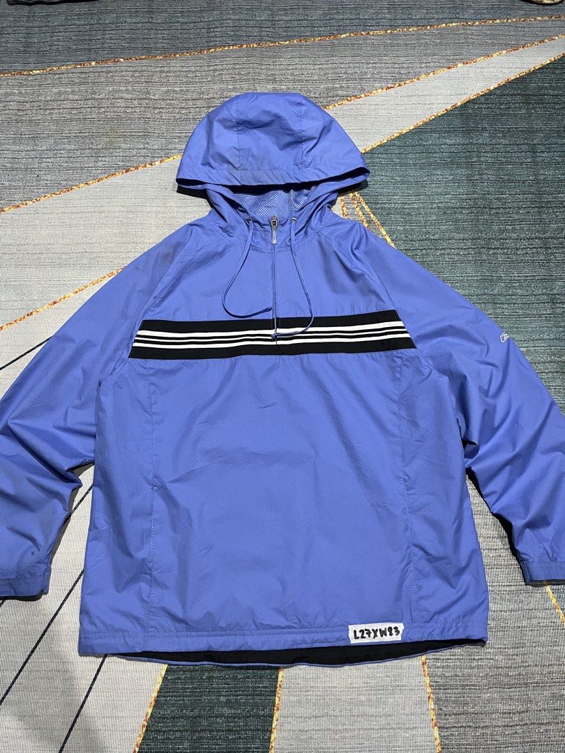 Reebok Blue Windbreaker Jacket with Black and White Stripes (Category: Coats, Jackets and Outerwear) located in Puerto Princesa. Submitted by dijaydj28 (Listing ID 1464590413, Image 1). Description: - Cool blue Reebok windbreaker jacket - Features a hood and half-zip closure - Stylish black stripe with white accents across chest and back - Ideal for casual outings and light outdoor activities - Lightweight and packable for on-the-go convenience.