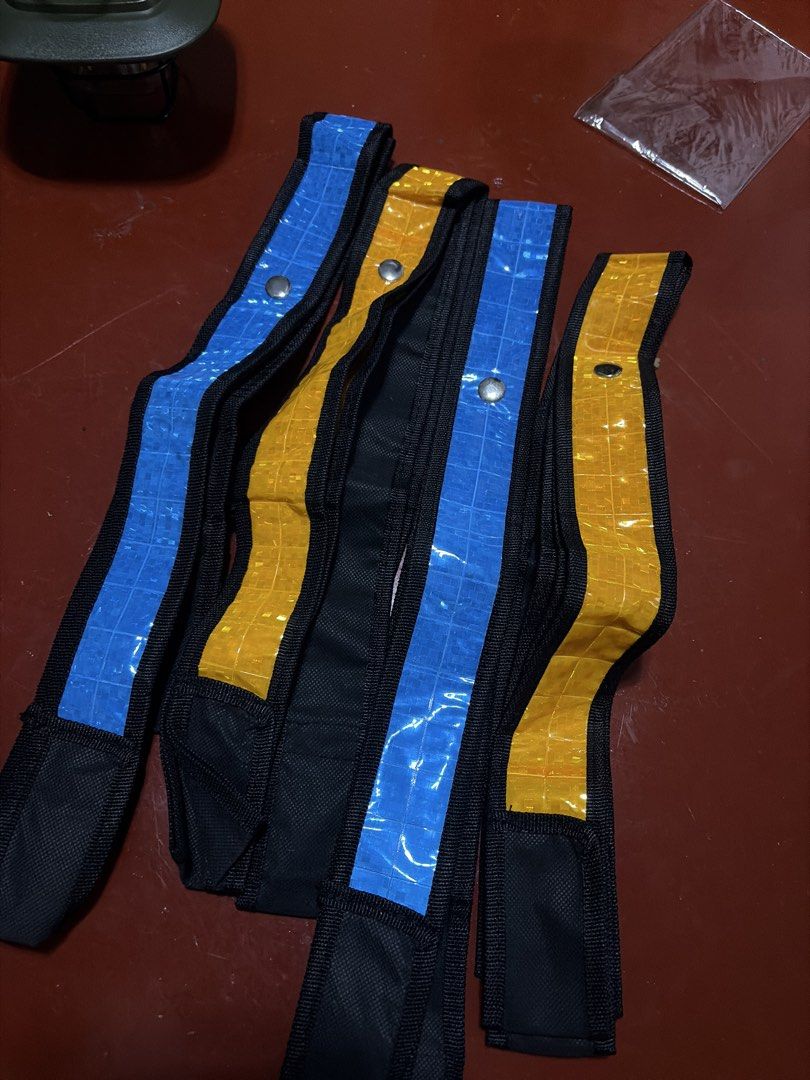 Reflective Safety Bands High Visibility Straps (Category: Vests) located in Manila. Submitted by finderskeepersmnl_092026 (Listing ID 1464715540, Image 1). Description: - Set of 4 reflective safety vest in vibrant blue and yellow - Durable black fabric trim along the edges for extra durability - Secure metal snap buttons for easy adjustment and fastening - Distinct grid pattern on the high-visibility reflective material - Ideal for night running,