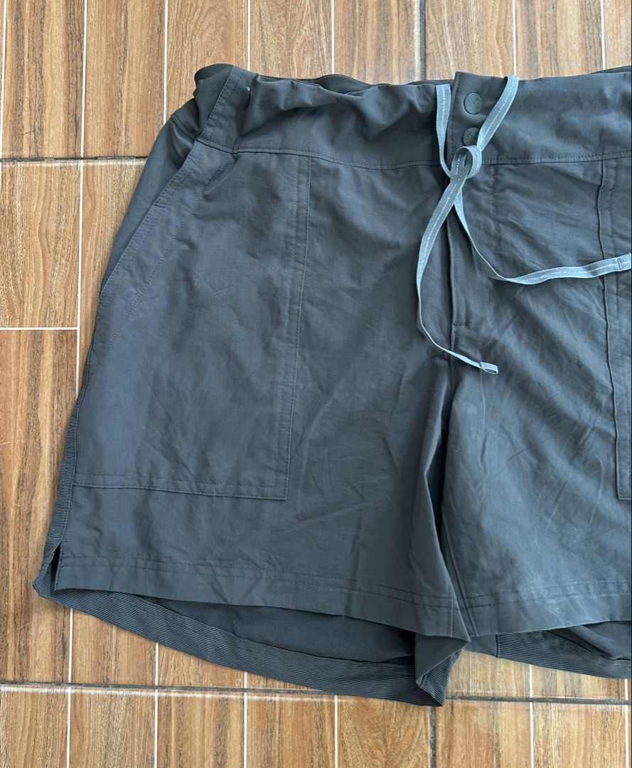 REI Dark Green Drawstring Athletic Shorts (Category: Shorts) located in Cagayan de Oro. Submitted by aljay02 (Listing ID 1464709248, Image 3). Description: Dark green outdoor shorts with an adjustable drawstring waist and dual front pockets. Side ribbed panels give extra stretch and movement. Flat waistband with button closure. Laid-flat waist measures approximately 19 inches across. Lightweight material suited for casual wear, hiking, or active 
