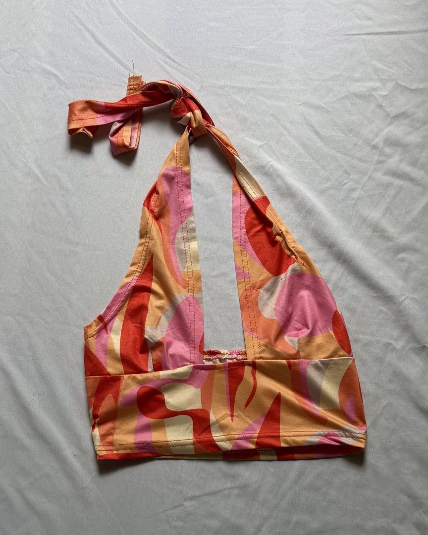 Retro Abstract Halter Crop Top (Category: Sleeveless) located in Santa Rosa. Submitted by itskllycstll (Listing ID 1464721004, Image 1). Description: - Vibrant orange, pink, and cream abstract print - Deep plunge neckline with a self-tie neck strap - Cropped length with a straight hem - Smooth, lightweight, and comfortable fabric - True to size, perfect for summer festivals or the beach - Easy to style with high-waisted denim.