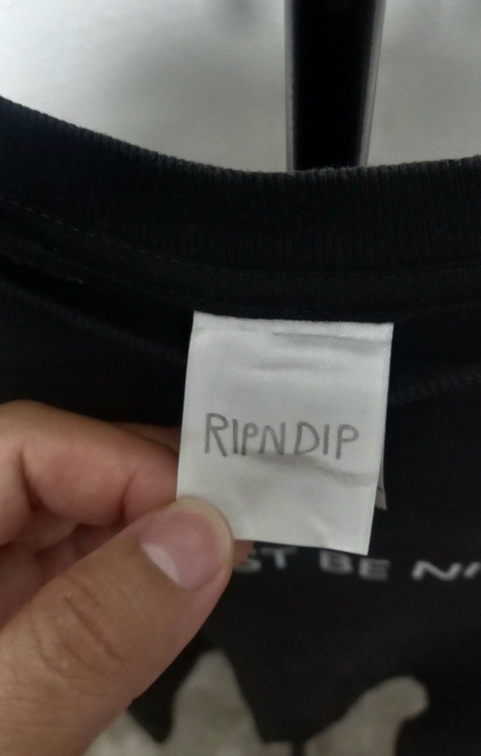 RIPNDIP "Must Be Nice" Graphic T-Shirt (Category: Shirts) located in Tarlac. Submitted by den420 (Listing ID 1464657456, Image 3). Description: - Brand: RIPNDIP - Design: 'Must Be Nice' text on front, iconic RIPNDIP cat graphic on back - Material: 100% Cotton - Size: Tagged Small - Style: Casual wear.