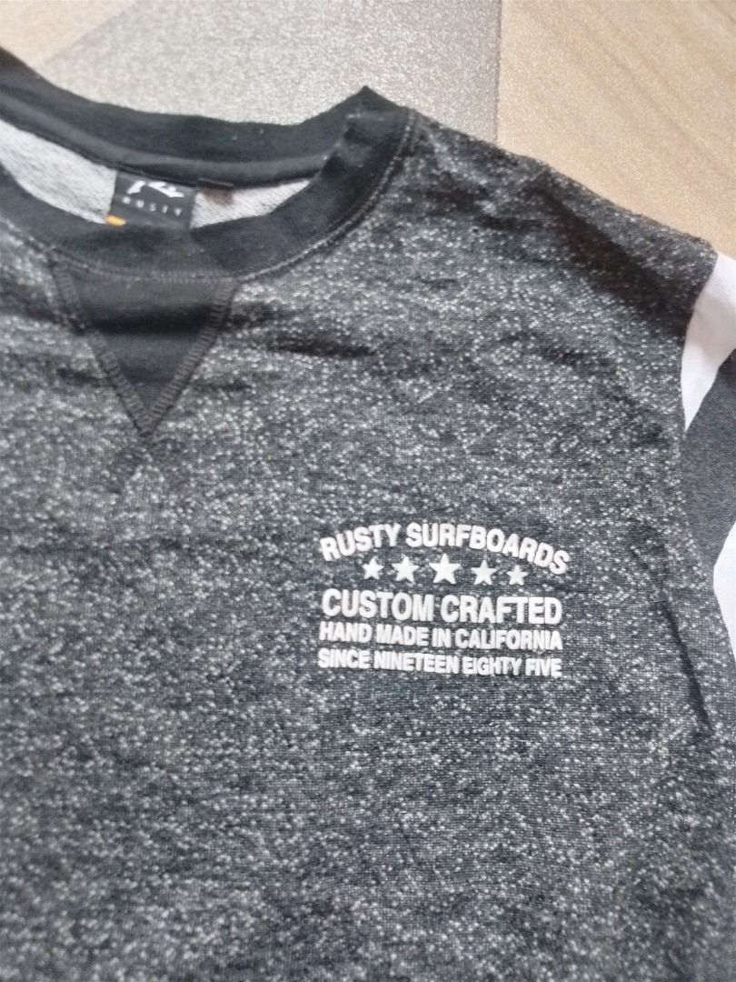 Rusty Surfboards Custom Crafted Crewneck Sweatshirt (Category: Coats, Jackets and Outerwear) located in Caloocan City. Submitted by hmm_shop83 (Listing ID 1464631953, Image 2). Description: - Brand: Rusty Surfboards - Type: Crewneck Sweatshirt - Color: Grey Marl - Size: M - Features: Graphic print on front and back ('Rusty Surfboards Custom Crafted Hand Made In California Since Nineteen Eighty Five'), striped sleeves (grey and white) - Style: Cas