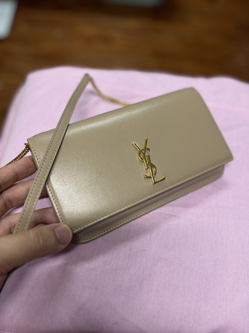 Saint Laurent Cassandre Mini Bag (Category: Luxury Bags & Wallets) located in Makati City. Submitted by tp8904 (Listing ID 1464687981, Image 1). Description: A Saint Laurent cell phone holder featuring the iconic Cassandre logo on the front flap, with a leather-and-chain shoulder strap. * Material: Calfskin leather and brass * Hardware: Gold-toned * Size: 18.5 × 11 × 2.5 cm (7 × 4.3 × 0.9 in) * Strap drop: 50 cm (19.7 in) * Closure: Snap button *