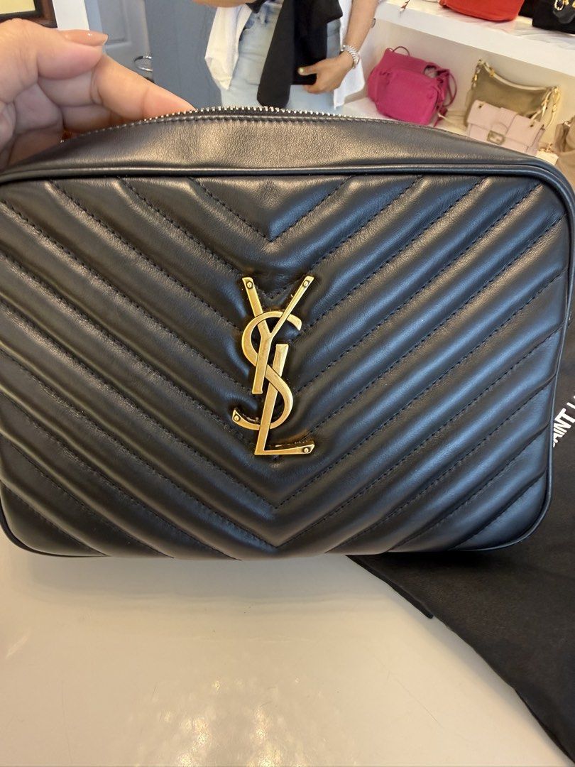 Saint Laurent Lou Camera Bag Black Gold Hardware (Category: Luxury Bags & Wallets) located in Alfonso. Submitted by luxurose (Listing ID 1464759934, Image 3). Description: - Brand: Saint Laurent (YSL) - Material: Black chevron quilted leather - Hardware: Iconic gold YSL monogram - Closure: Secure zip top - Interior: Fabric lining with a convenient slip pocket - Inclusions: Comes with matching black dust bag and box - Condition: Excellent, great f