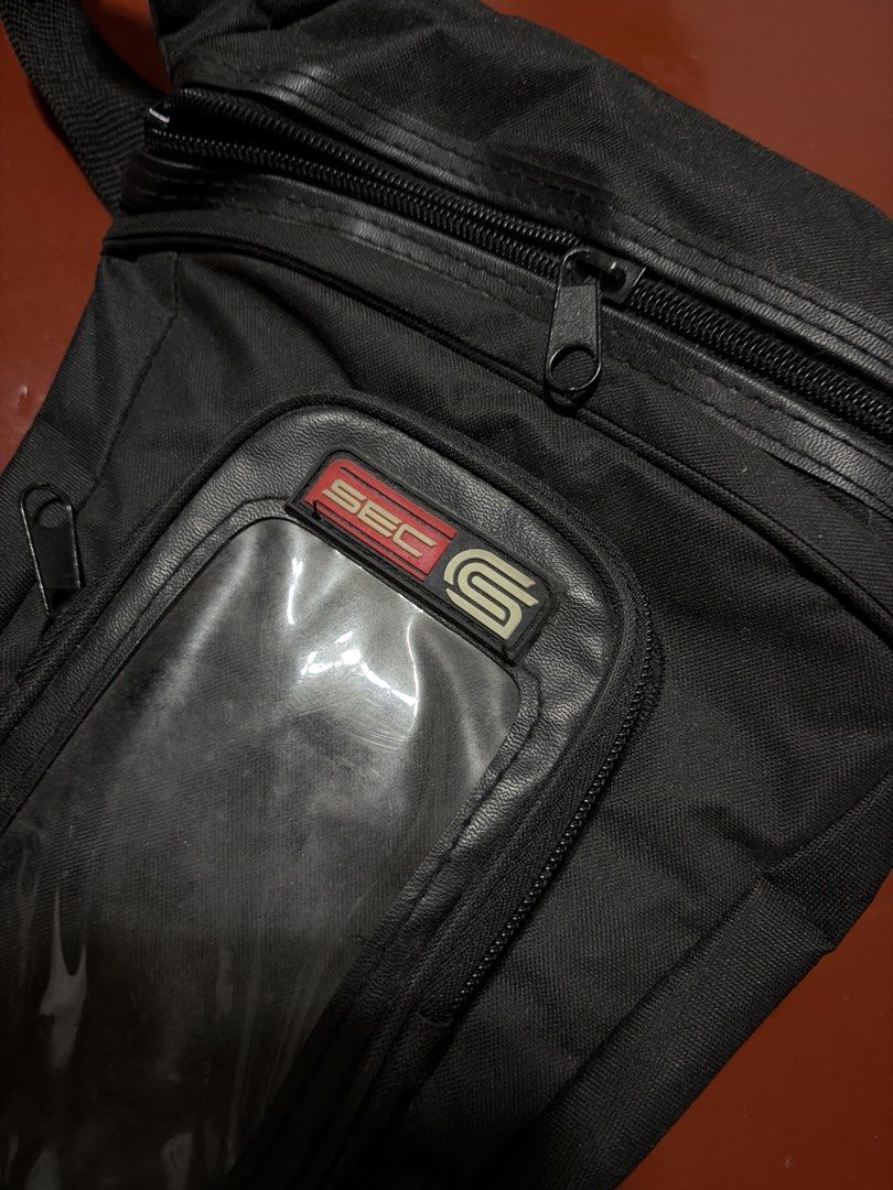 SEC Motorcycle Drop Leg Bag Tactical Thigh Pouch (Category: Belt bags, Clutches and Pouches) located in Manila. Submitted by finderskeepersmnl_092026 (Listing ID 1464720800, Image 2). Description: Black SEC motorcycle leg bag up for grabs. Handy tactical drop leg pouch with multiple zipped compartments and adjustable buckle straps. Transparent window on the front flap for easy viewing of phone or maps while riding. Durable fabric construction kee