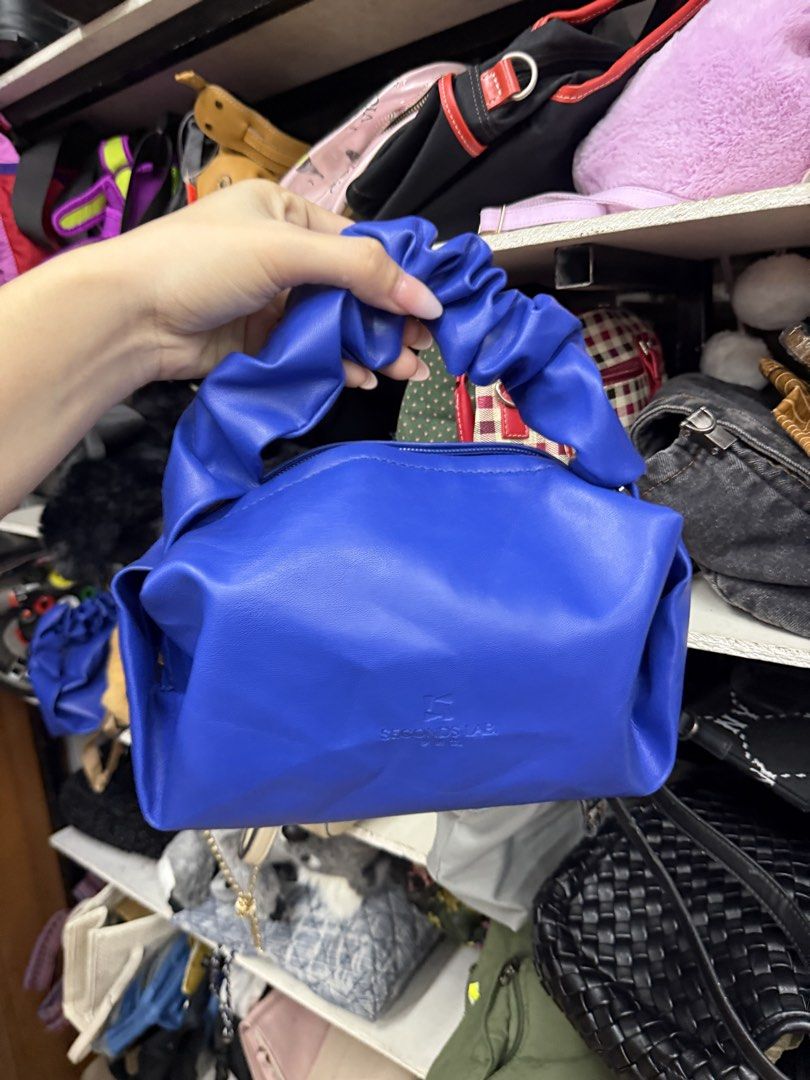 SECONDS LAB Royal Blue Scrunch Handle Handbag (Category: Shoulder Bags) located in Manila. Submitted by fastlion.584bdf (Listing ID 1464738501, Image 1). Description: - Color: Bright royal blue - Material: Smooth faux leather - Design: Unique scrunched puffy handle and structured rectangular body - Closure: Secure zip top - Details: Subtle embossed logo on front - Capacity: Compact size, fits phone, keys, and cards easily - Style: Adds a vibrant 