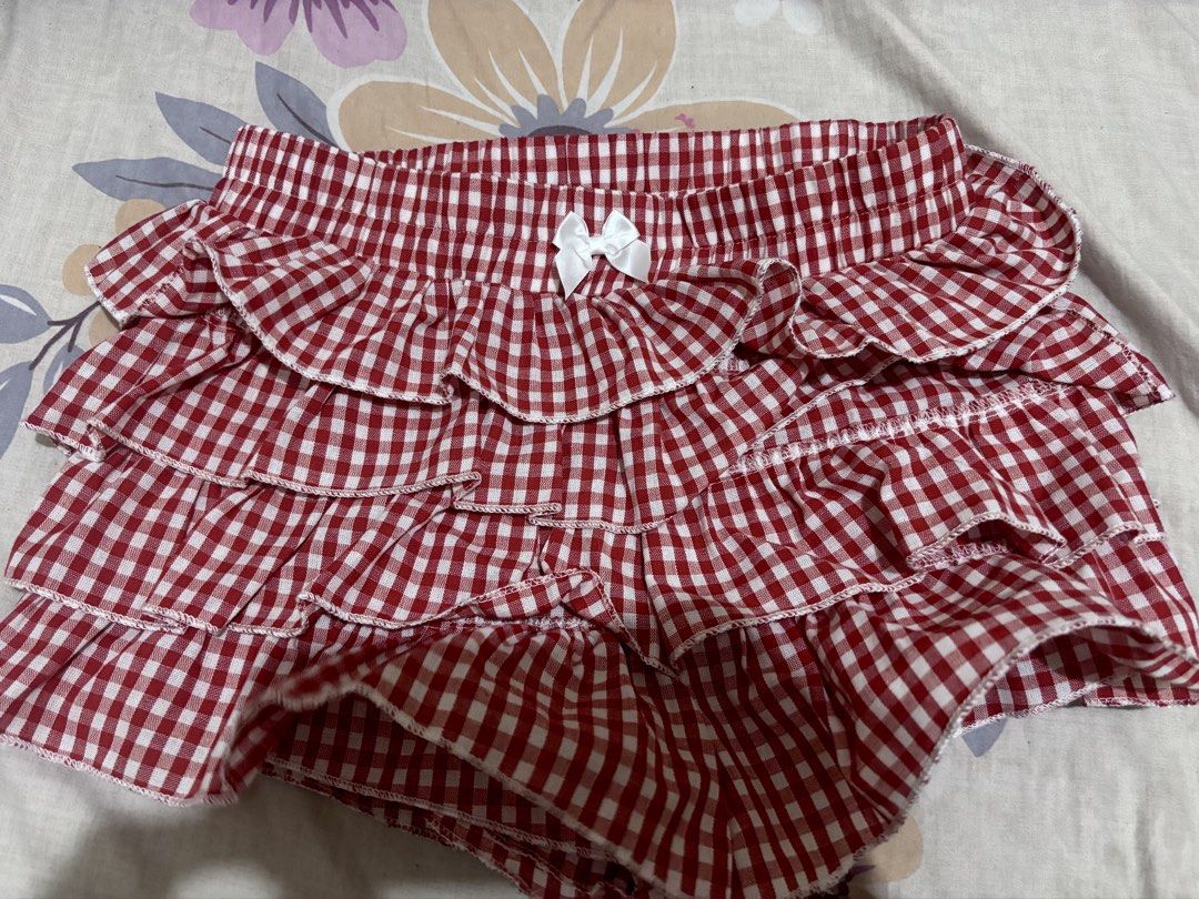 SHEIN Red Gingham Ruffle Skirt Size XS (Category: Skirts) located in Bacoor. Submitted by fmax19 (Listing ID 1464743074, Image 1). Description: - Brand: SHEIN - Style: Red and white gingham print with multi-tiered ruffles and a front center bow - Worn once only - Original price is 500.
