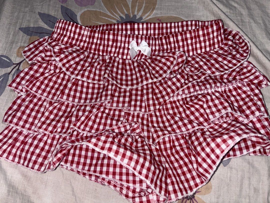 SHEIN Red Gingham Ruffle Skirt Size XS (Category: Skirts) located in Bacoor. Submitted by fmax19 (Listing ID 1464743074, Image 2). Description: - Brand: SHEIN - Style: Red and white gingham print with multi-tiered ruffles and a front center bow - Worn once only - Original price is 500.