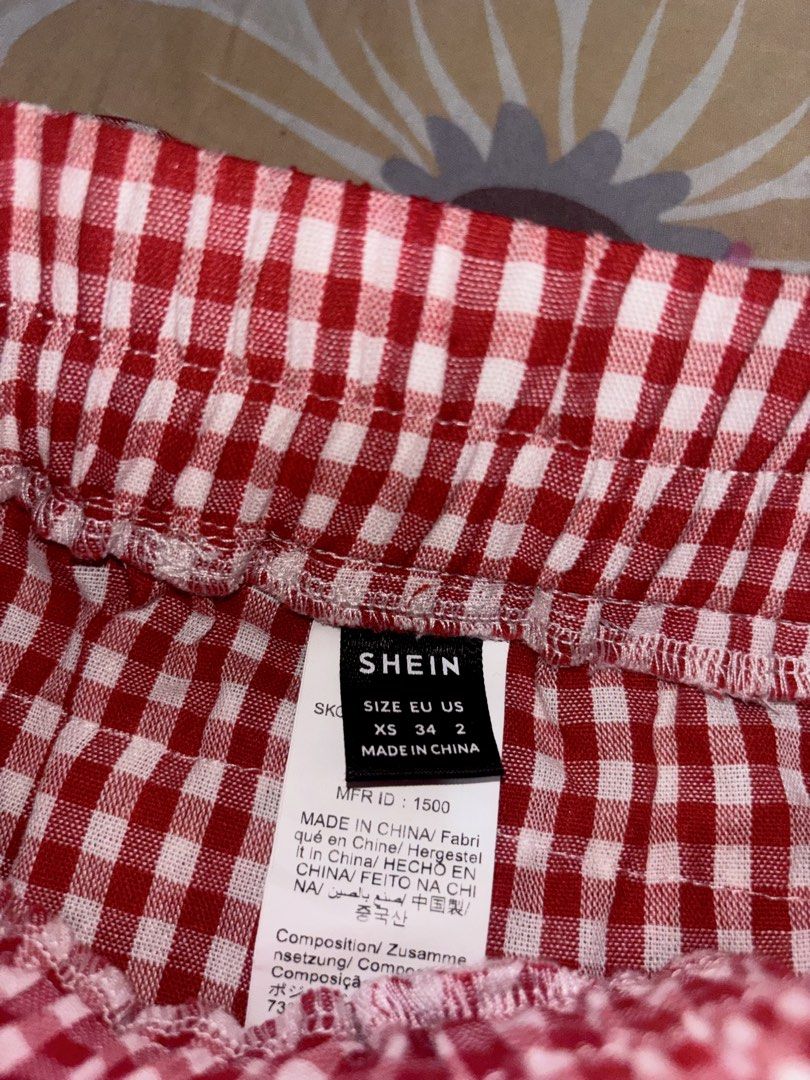 SHEIN Red Gingham Ruffle Skirt Size XS (Category: Skirts) located in Bacoor. Submitted by fmax19 (Listing ID 1464743074, Image 3). Description: - Brand: SHEIN - Style: Red and white gingham print with multi-tiered ruffles and a front center bow - Worn once only - Original price is 500.