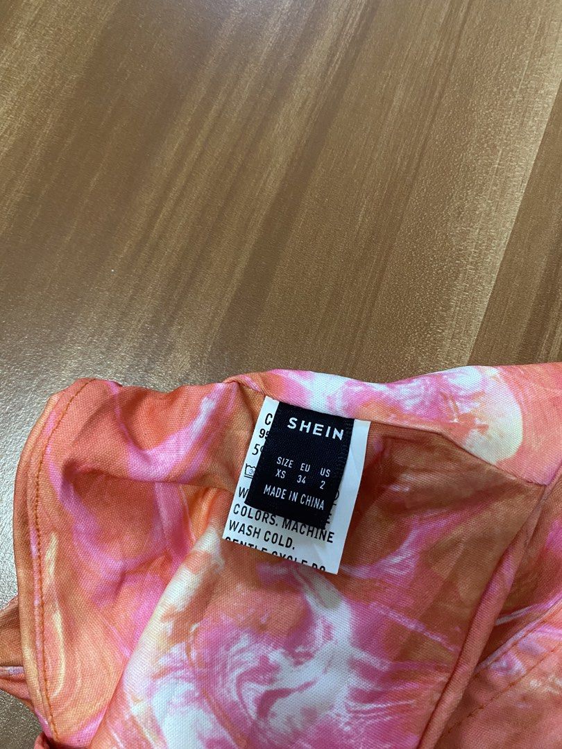 SHEIN Ruched Marble Print Tube Top (Category: Sleeveless) located in Manila. Submitted by reginemarquez412 (Listing ID 1464663166, Image 2). Description: - Trendy tube top with a unique marble print - Features eye-catching orange, pink, and white swirl patterns - Ruching details along the front for added style - Made from a stretchy material for a comfortable fit - Versatile piece for casual outings or a night on the town.