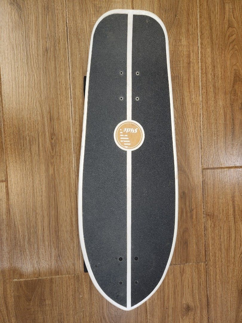 Slide Surfskate Board (Category: Skates, Rollerblades & Scooters) located in Caloocan City. Submitted by noblestorm_c6463a (Listing ID 1464749797, Image 2). Description: - Brand: Slide surfskate - Deck: Black grip tape with a white center stripe and a red-tipped splatter paint design underneath - Wheels: Black with Slide branding - Condition: Minor scuffs and scrapes on the tail edge from normal riding, trucks and wheels roll smooth - Ideal for: 