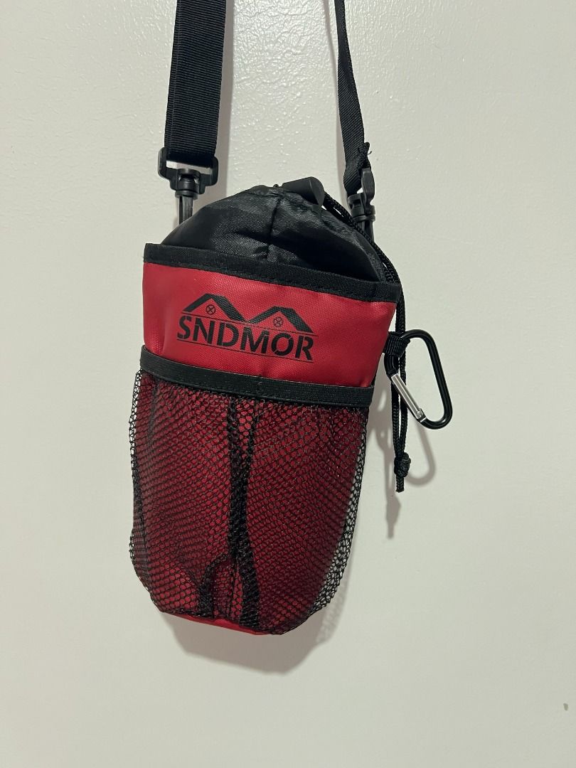 SNDM Water Bottle Holder Maroon with Strap (Category: Water Bottles & Tumblers) located in Davao. Submitted by jpnusapasabuyfindsdvo (Listing ID 1464699223, Image 2). Description: - Brand/Model: SNDM Water Bottle Holder - Color: Maroon and black - Material: Durable fabric with quick-drying, breathable mesh body - Closure: Secure drawstring top - Portability: Includes an adjustable black strap and a carabiner clip - Ideal For: Daily walks, hikes, 