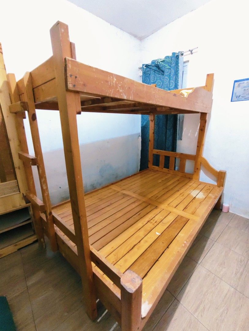 Solid Wood Bunk Bed Double Bottom Single Top (Category: Bed Frames & Mattresses) located in Bulacan. Submitted by babz30261 (Listing ID 1464692594, Image 3). Description: - Wooden bunk bed frame with built-in side ladder - Size: Double mattress space on bottom, single on top SOLID WOODEN PALOCHINA - Condition: Sturdy and solid structure, with minor scratches and scuffs from normal use - Note: Requires self-disassembly for transport.