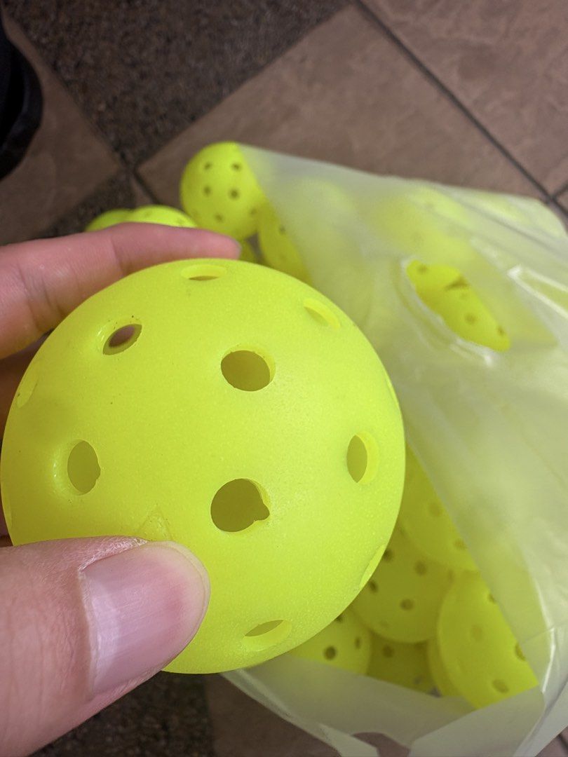 Some pickleballs (defect) (Category: Racket & Ball Sports) located in Subang Jaya. Submitted by bennn.jiahao (Listing ID 1464651521, Image 2). Description: Usable defect balls Tournament grade ✅ 10 - RM20 50 - RM100 Great for drills and social Meet up subang USJ.