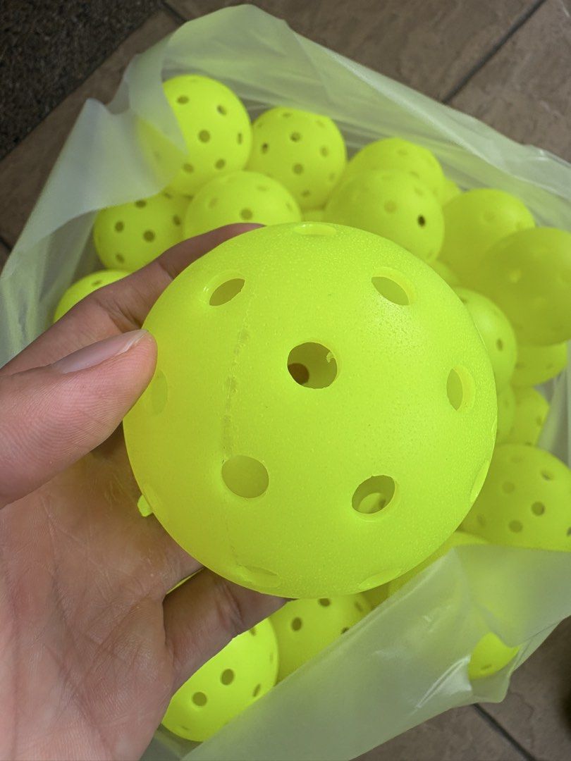 Some pickleballs (defect) (Category: Racket & Ball Sports) located in Subang Jaya. Submitted by bennn.jiahao (Listing ID 1464651521, Image 3). Description: Usable defect balls Tournament grade ✅ 10 - RM20 50 - RM100 Great for drills and social Meet up subang USJ.