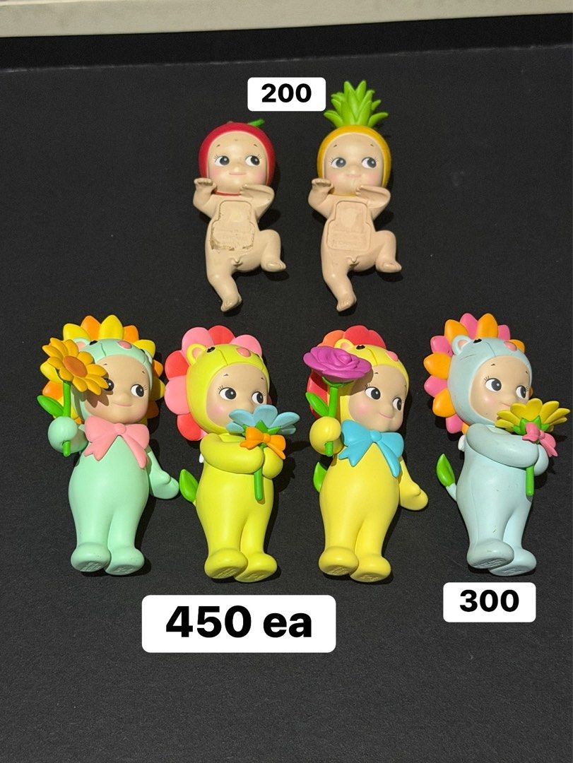 Sonny Angel Figures - Various Series & Prices (Category: Designer & Blind Box Toys) located in Manila. Submitted by medv27 (Listing ID 1464602329, Image 1). Description: - Sonny Angel collectible figures available. - Prices: - Top row pair: PHP 200 ea - Middle row: PHP 450 each - Bottom right: PHP 300 - birthday : PHP 500 - Sonny Angel pouch: PHP 250 - Ideal for collectors, display, or as a gift..