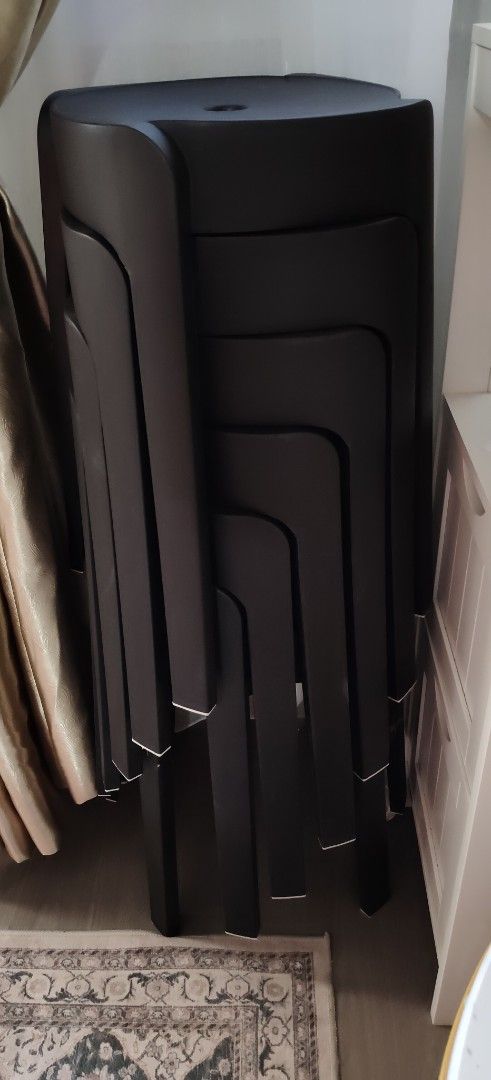 Stackable black plastic stools set (Category: Chairs) located in Singapore. Submitted by mar0425 (Listing ID 1464725190, Image 1). Description: - Colour: Black - Material: Sturdy plastic with a sleek matte finish - Space-saving: Vertically stackable to maximize floor space - Convenient design: Built-in finger holes on the seat for easy lifting and carrying - Condition: Clean overall with minimal signs of wear.