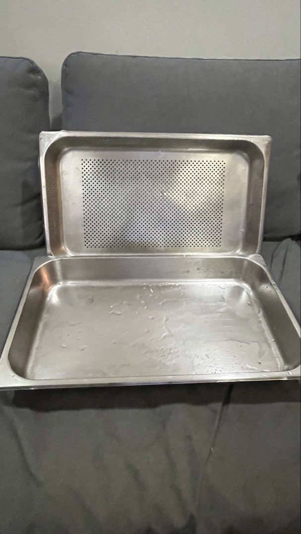 Stainless Steel Perforated Pan Set (Category: Cookware & Accessories) located in Pasig City. Submitted by tylernchloe (Listing ID 1464602127, Image 3). Description: - Set of 2 stainless steel pans - Includes one solid pan and one perforated pan - Size: (Deep - L 21in, W 13in, H 6in / 4in) - (Shallow - L 21in, W 13in, H 3in - Ideal for draining, steaming, and other cooking methods - Made from durable, easy-to-clean stainless steel - Suitable for b