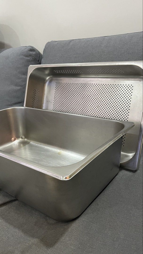 Stainless Steel Perforated Pan Set (Category: Cookware & Accessories) located in Pasig City. Submitted by tylernchloe (Listing ID 1464602127, Image 1). Description: - Set of 2 stainless steel pans - Includes one solid pan and one perforated pan - Size: (Deep - L 21in, W 13in, H 6in / 4in) - (Shallow - L 21in, W 13in, H 3in - Ideal for draining, steaming, and other cooking methods - Made from durable, easy-to-clean stainless steel - Suitable for b