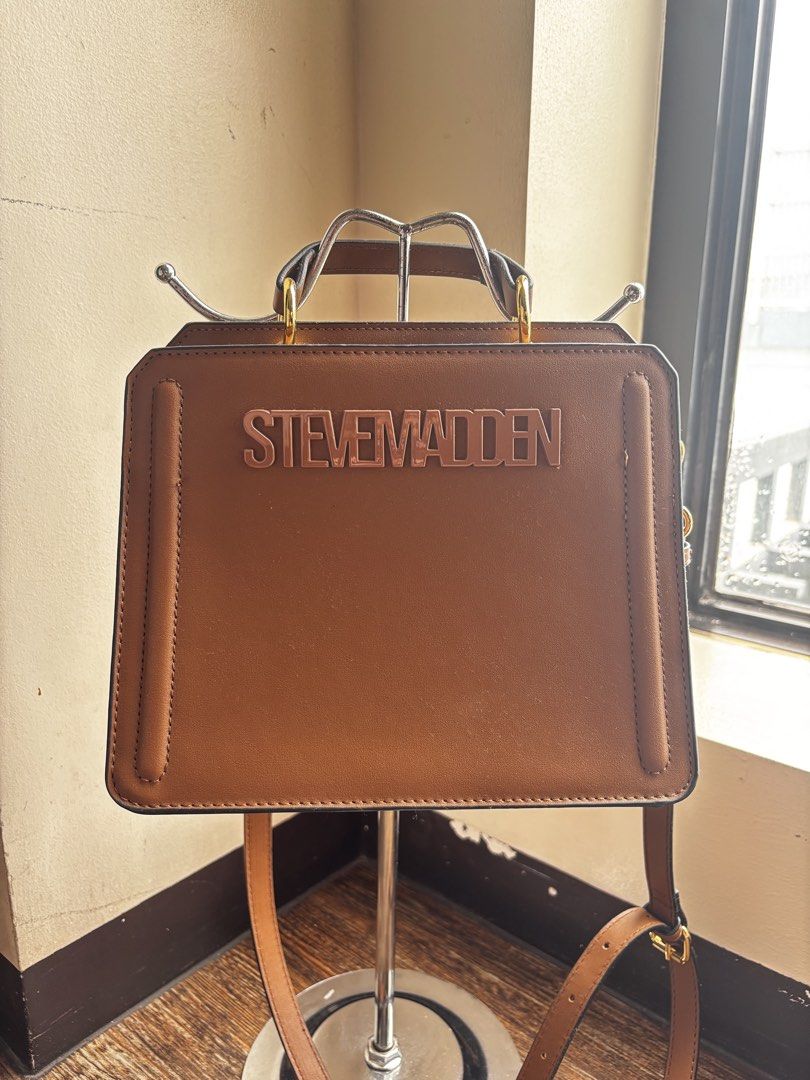 Steve Madden Brown Leather Handbag (Category: Luxury Bags & Wallets) located in Manila. Submitted by fiercewater-8107 (Listing ID 1464595751, Image 1). Description: - NEGOTIABLE - Brand: Steve Madden - Material: Brown Leather - Features: Top handle, detachable shoulder strap - Accent: Rose gold Steve Madden logo on front - Style: Clean, classic, versatile - Ideal for: Everyday use or dressing up.