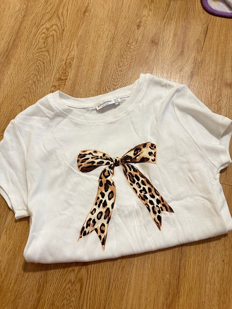 [STRADIVARIUS] leopard bow fitted tee (Category: Shirts) located in Cainta. Submitted by m4tchyyy (Listing ID 1464659569, Image 1). Description: 🍀 mode of payment: gcash or bdo 🍀 mode of delivery: j&t express, ggx, or same day delivery within metro manila feel free to inquire! 🩷.