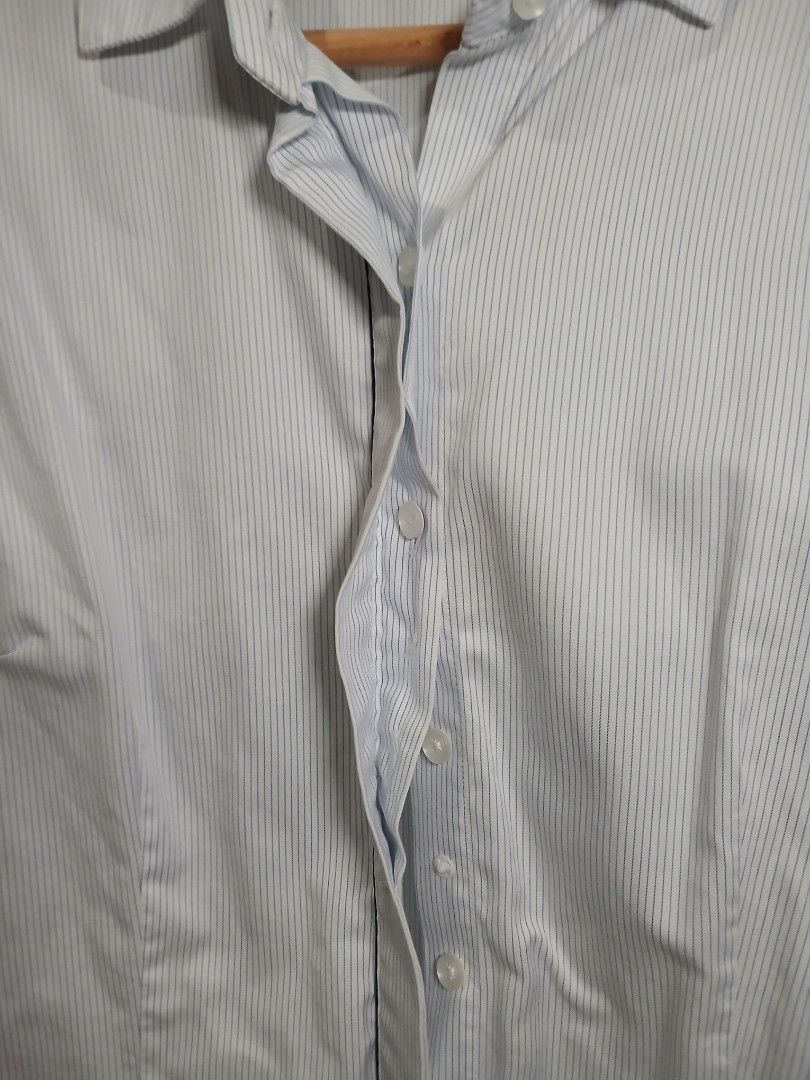 Striped long sleeve / Office wear (S-M) (Category: Longsleeves) located in Pasig City. Submitted by carmelaelizalde (Listing ID 1464737331, Image 3). Description: Color/Pattern: White with thin blue pinstripes Collar, front button closure, and button cuffs Hidden button, with snap every after buttons RFS: decluttering .