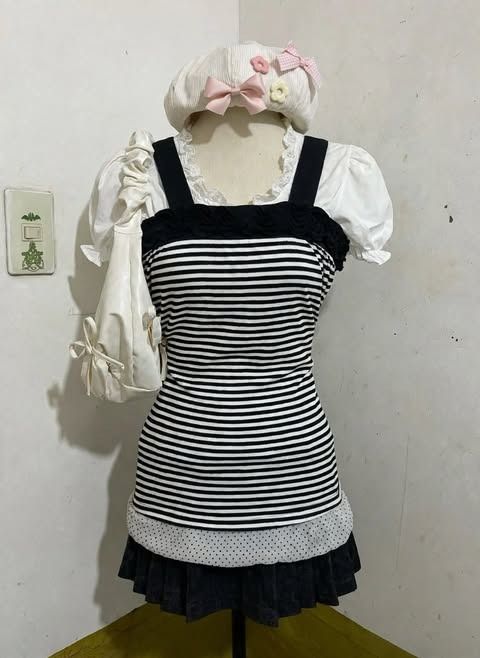 Striped Tank Top with Polka Dot Ruffle Hem (Category: Sleeveless) located in Manila. Submitted by angelic.clot (Listing ID 1463493676, Image 2). Description: - Classic black and white stripes - Features black straps - Adorable ruffled neckline - Cute polka dot ruffle at the hem - Ideal for everyday casual wear.