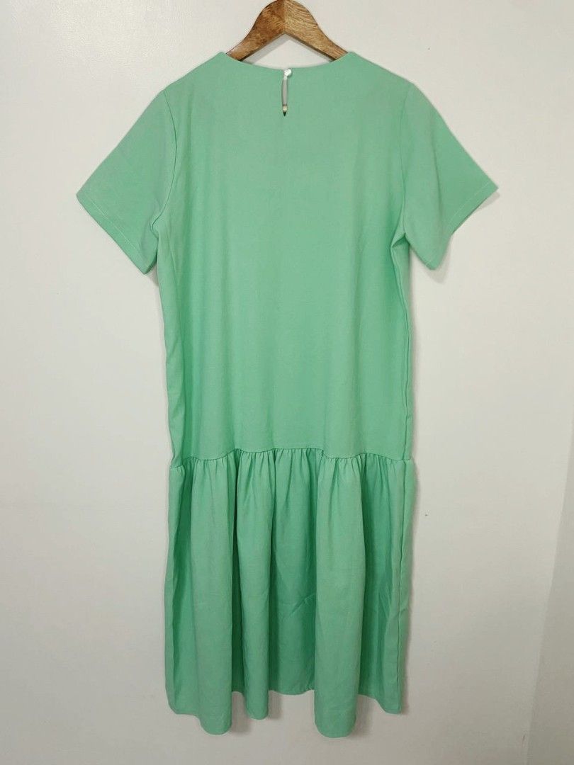 Studio White Mint Green Drop Waist Dress (Category: Dresses) located in Laoag. Submitted by __baptistakim (Listing ID 1464709760, Image 2). Description: Mint green midi dress from Studio White. Short sleeves, round neckline, drop waist with pleated skirt detail. Back button closure at the neck. Bust and waist fit up to 42 inches. Total length is 45 inches..