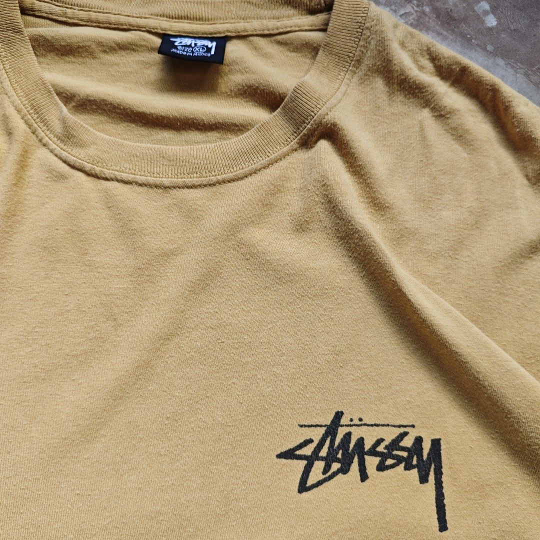 Stussy Big Link Tee 21SS (Category: Tshirts & Polo Shirts ) located in Ipil. Submitted by ajthriftfinds (Listing ID 1464637473, Image 3). Description: - Classic Stussy T-shirt - Color: Mustard Yellow - Size: Tagged XL - Design: Iconic Stussy logo on front, large circular logo on back - Material: 100% Cotton - Perfect for everyday wear.