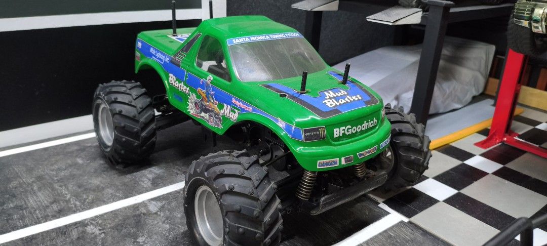 Tamiya Mud Blaster RC Monster Truck (Category: Remote Control Toys) located in Caloocan City. Submitted by Outlaw (Listing ID 1464591771, Image 2). Description: - Tamiya Mud Blaster RC monster truck - Color: Green - Features large, chunky tires for off-road action - 'White Lightning Inc.' and 'BFGoodrich' decals - Black chassis shows some signs of use - Ready for rough terrain fun - Ideal for collectors or hobbyists For sale Tamiya Wild Dagger ro