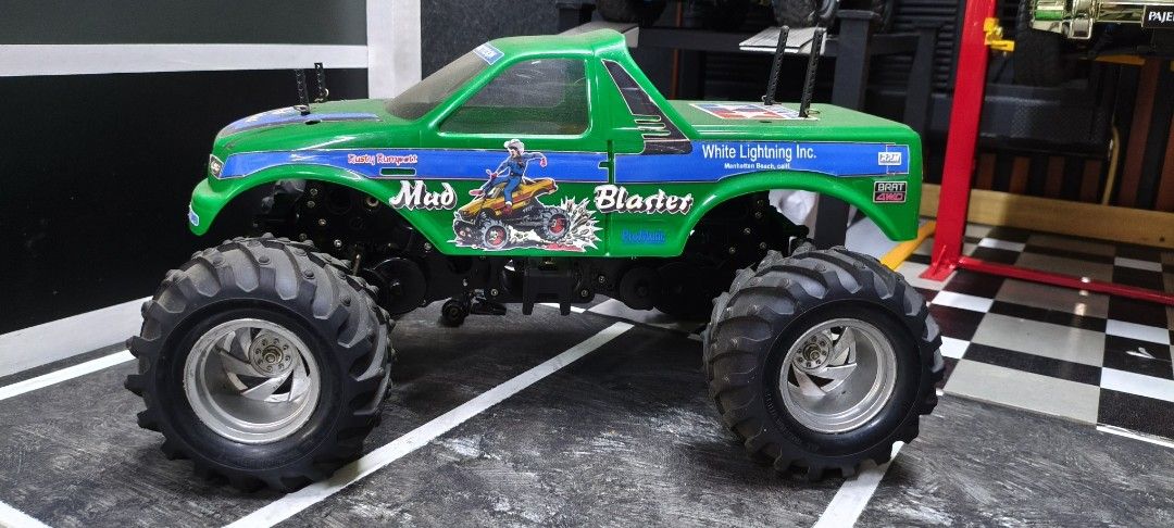Tamiya Mud Blaster RC Monster Truck (Category: Remote Control Toys) located in Caloocan City. Submitted by Outlaw (Listing ID 1464591771, Image 3). Description: - Tamiya Mud Blaster RC monster truck - Color: Green - Features large, chunky tires for off-road action - 'White Lightning Inc.' and 'BFGoodrich' decals - Black chassis shows some signs of use - Ready for rough terrain fun - Ideal for collectors or hobbyists For sale Tamiya Wild Dagger ro