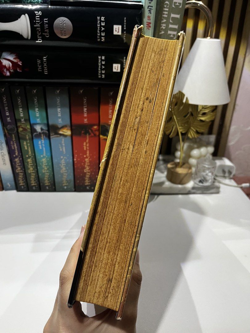 The Lost Symbol – Dan Brown (Category: Storybooks) located in Manila. Submitted by sophie.navs (Listing ID 1464726365, Image 3). Description: The Lost Symbol – Dan Brown Bought it originally for ₱1k before Format: Authentic Hardbound / Hardcover (with Dust Jacket) ‼️ Condition: Heavily Damaged due to storage / Reading Copy ‼️ Details: Outer dust jacket, board edges, and page block show visible foxing, aging, and storage wear Hardcover structure, 