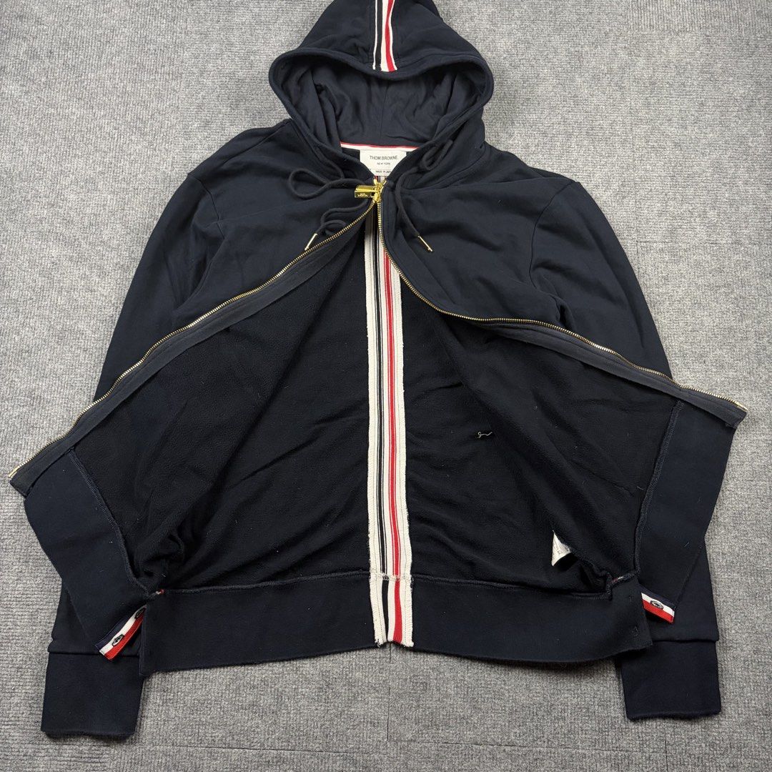 Thom Browne Loopback Center Back Stripe Zip-Up Hoodie (Category: Luxury Apparel) located in Manila. Submitted by yourtherapist_ (Listing ID 1464709218, Image 3). Description: Thom Browne Loopback Center Back Stripe Zip-Up Hoodie Size: 4 Condition: Excellent Made in: Japan Measurements Width: 21.5 Length: 28 Shoulder: 20 Sleeve: 26 .