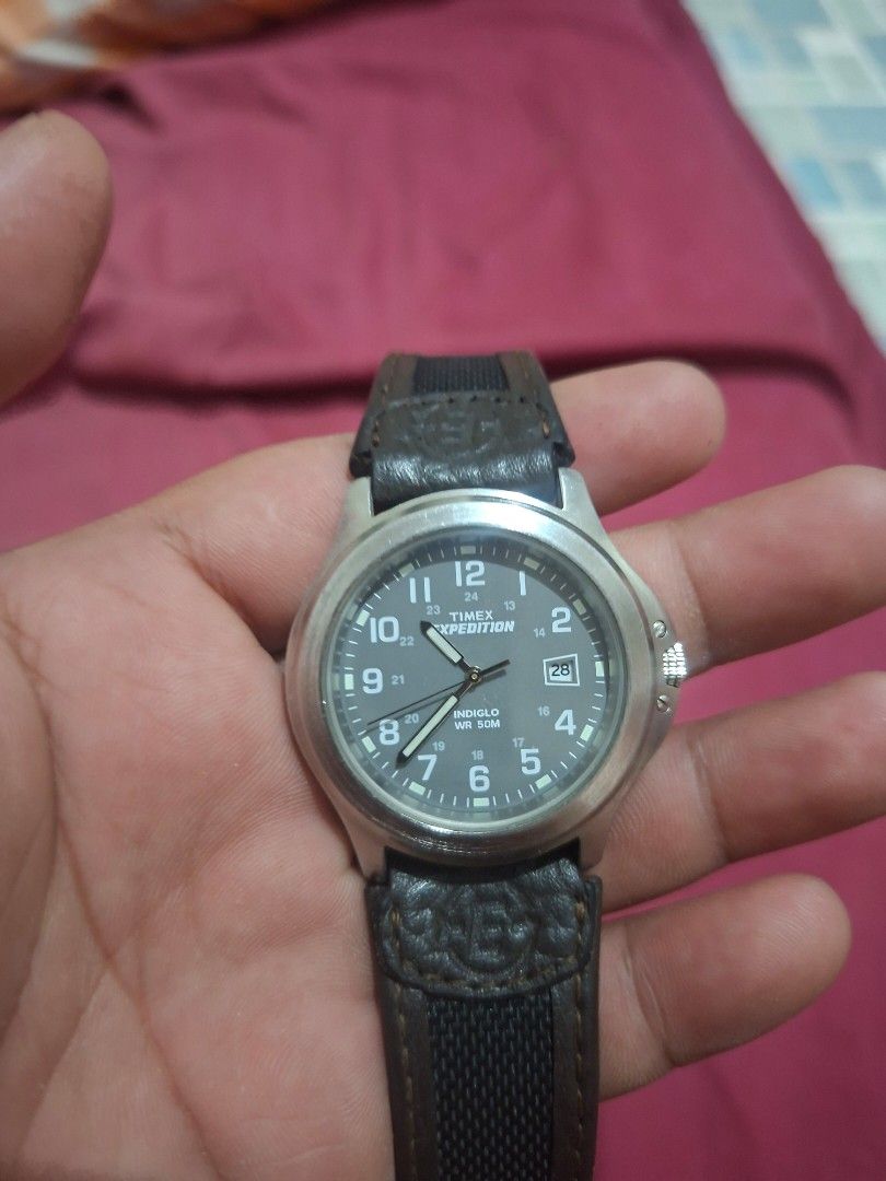 Timex Expedition Watch with Leather and Nylon Strap (Category: Men's Watches) located in Lapu Lapu. Submitted by margaux099 (Listing ID 1464658986, Image 2). Description: - Timex Expedition watch - Grey dial with clear numbers and date window - Water resistant up to 50 meters - Stainless steel back - Comes with dark brown leather strap and black nylon strap - Buckle closure - Ideal for everyday wear and outdoor adventures.