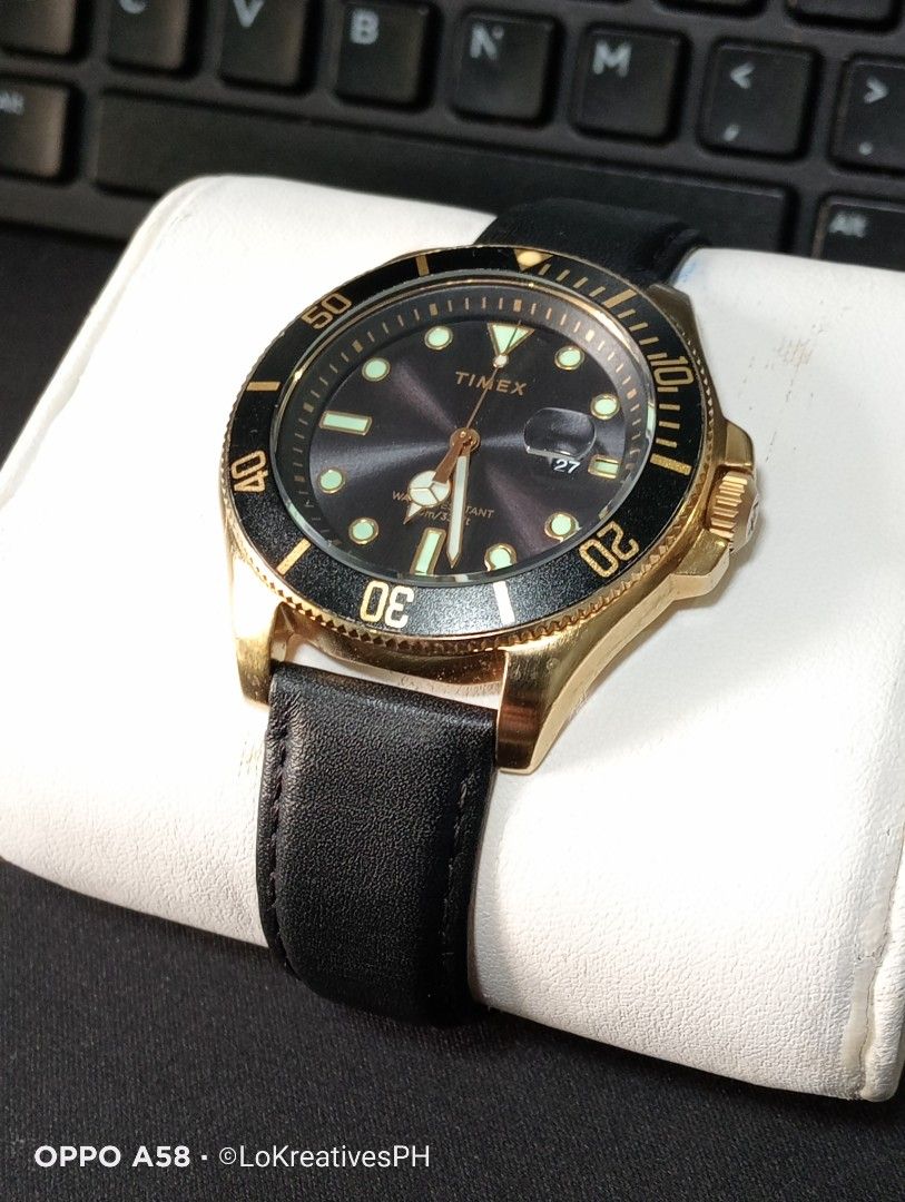 Timex Harborside Coast (Category: Men's Watches) located in Cavite. Submitted by purpose_served (Listing ID 1464763136, Image 2). Description: Timex Harborside Coast Quartz Black Dial Men's Watch Gold-tone low lead brass case with a black leather strap. Rotating black low lead brass bezel. Black dial with gold-tone hands and dots hour markers. Minute markers around the outer rim. Dial Type: Analog. Date display at the 3 o'clock position. Quartz m