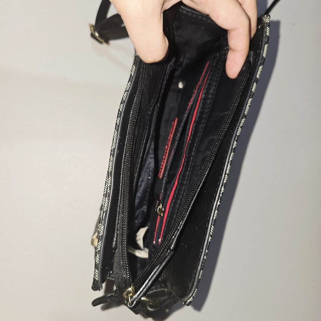 Tommy Hilfiger Monogram Crossbody Bag (Category: Cross-body Bags) located in Caloocan City. Submitted by wootteo1227 (Listing ID 1464738147, Image 3). Description: Tommy Hilfiger crossbody bag in black and white monogram print. Gold-tone hardware throughout. Long adjustable shoulder strap included. Front exterior slip pocket with metallic logo plaque. Multiple interior compartments with black lining, plus a zippered pocket featuring red accent tr