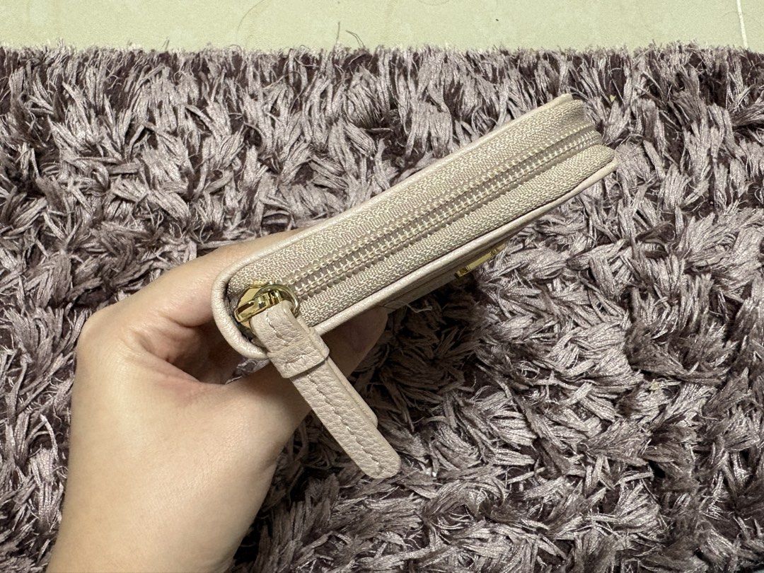 Tommy Hilfiger Monogram Zip-around Wallet (Pink/Beige) (Category: Wallets & Card holders) located in Quezon City. Submitted by jjccly (Listing ID 1464656168, Image 3). Description: brand new condi never used got as a gift from the US last year minor flaw: see last pic.