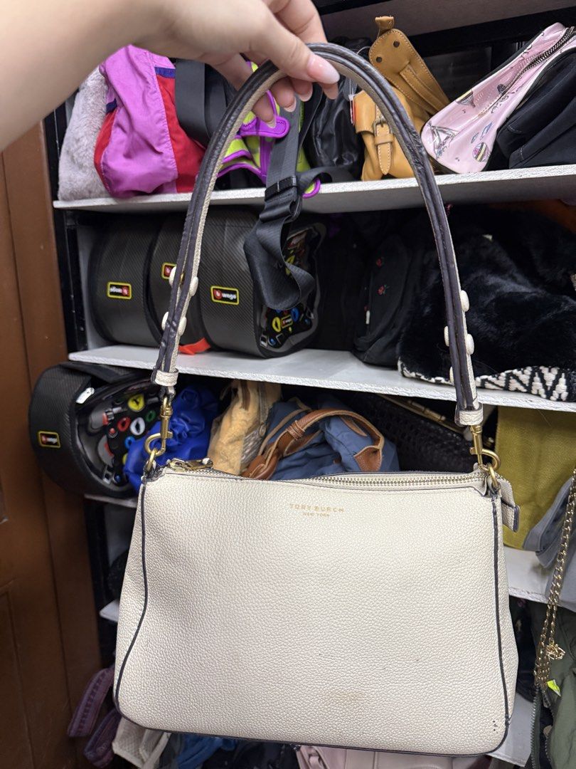 Tory Burch Beige Pebbled Leather Shoulder Bag (Category: Luxury Bags & Wallets) located in Manila. Submitted by fastlion.584bdf (Listing ID 1464738716, Image 1). Description: - Brand: Tory Burch - Material: Premium cream pebbled leather with contrasting dark brown edge trim - Hardware: Elegant gold-tone hardware - Closure: Secure top zipper closure - Features: Dual strap attachment rings, compact size perfect for daily essentials - Condition: Cle