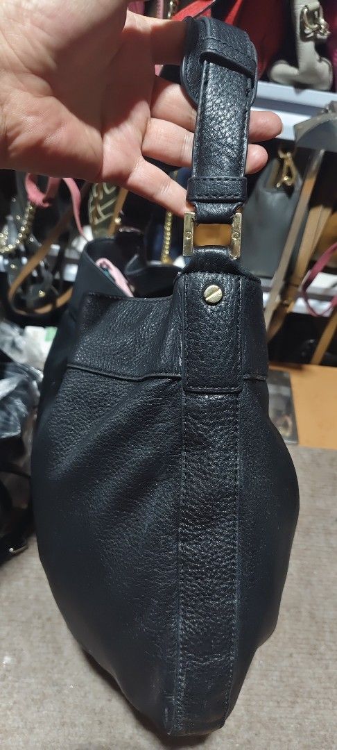 Tory Burch Black Leather Tote Bag (Category: Tote Bags) located in Solano. Submitted by chie_prelovedthriftshop (Listing ID 1464630897, Image 3). Description: Black leather Tory Burch tote bag. Spacious interior. Comfortable shoulder straps. Embossed Tory Burch logo on the front. Great everyday bag. Some signs of wear on the leather and hardware. needs wash inside.